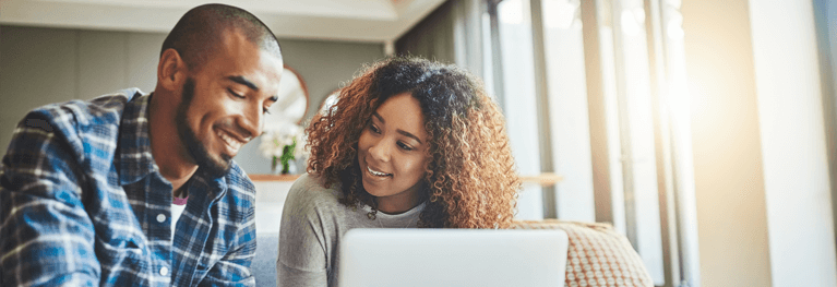 Two people looking at a laptop together